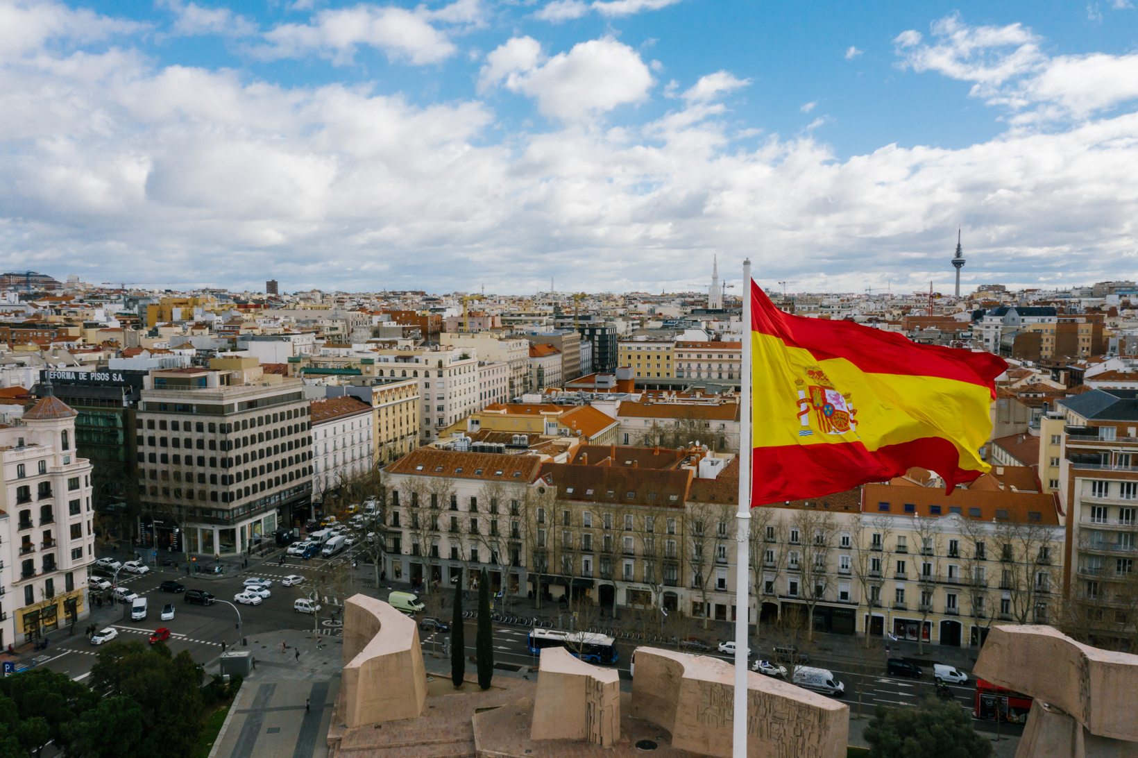 Spanish national flag against cityscape